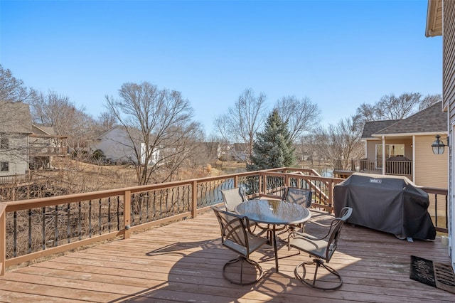 wooden terrace with grilling area and outdoor dining space