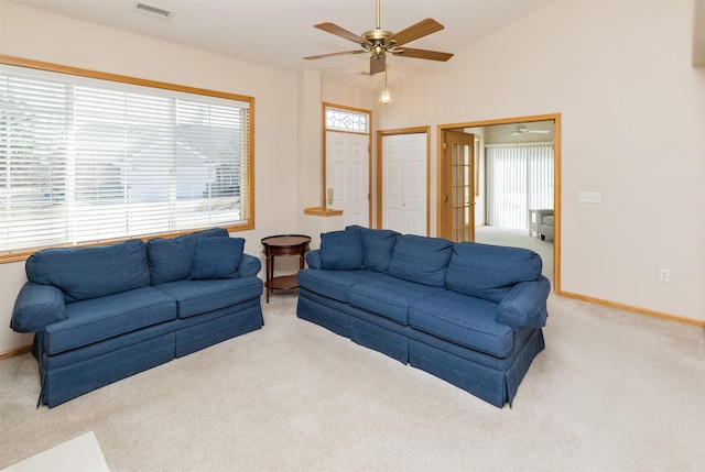 living room with lofted ceiling, light colored carpet, visible vents, and baseboards