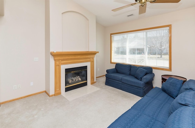 carpeted living area featuring visible vents, baseboards, a fireplace with flush hearth, and vaulted ceiling