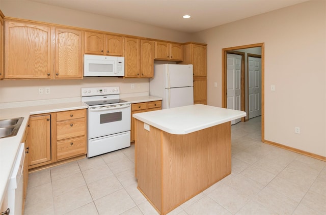 kitchen with recessed lighting, white appliances, a kitchen island, and light countertops