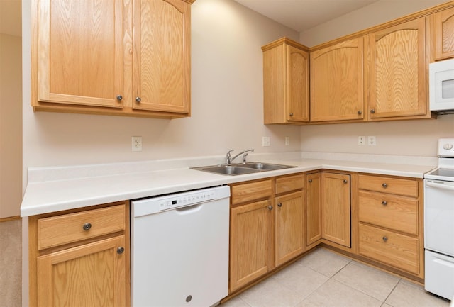 kitchen featuring white appliances, light tile patterned flooring, light brown cabinetry, a sink, and light countertops