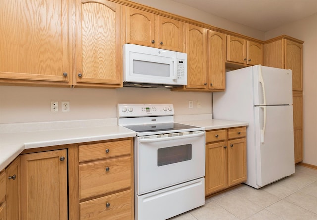 kitchen with white appliances, light tile patterned floors, and light countertops