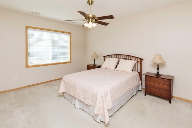 carpeted bedroom with baseboards, visible vents, and ceiling fan