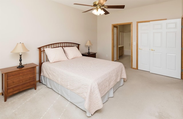 carpeted bedroom featuring ceiling fan and ensuite bath