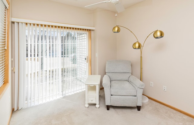 sitting room with carpet, baseboards, and ceiling fan