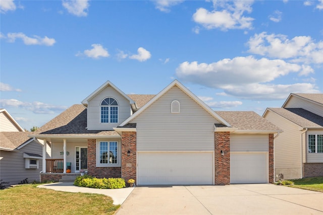 view of front of property featuring a front lawn, brick siding, a garage, and driveway