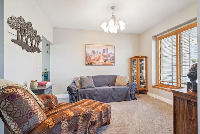 living room featuring baseboards, carpet floors, and a notable chandelier