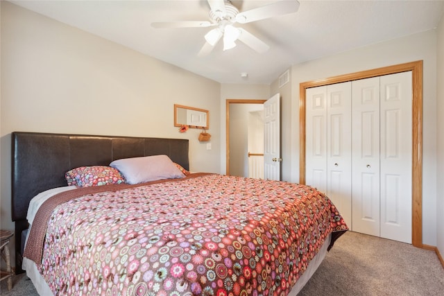 carpeted bedroom featuring a closet, visible vents, and a ceiling fan