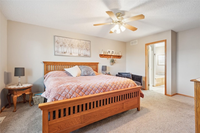 bedroom with baseboards, visible vents, ensuite bathroom, a textured ceiling, and carpet flooring