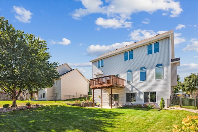 rear view of property with a yard, a deck, and fence private yard