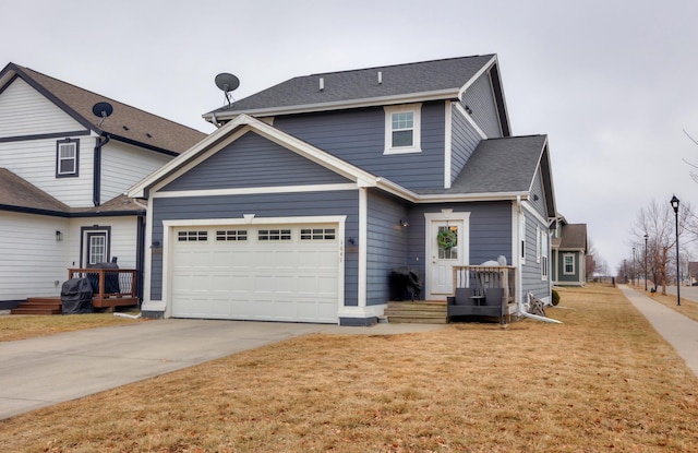 view of front of property with a front lawn, driveway, and a shingled roof