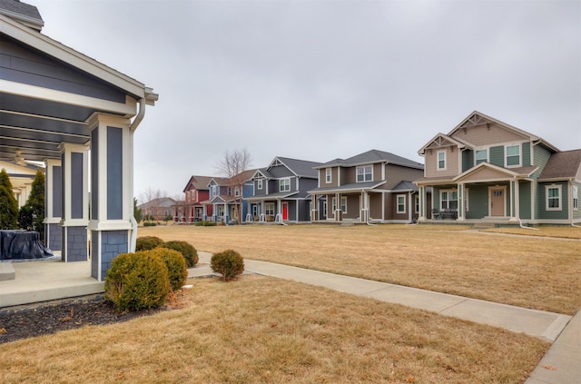 view of yard featuring a porch and a residential view