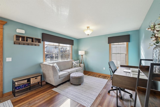 office area featuring baseboards and wood finished floors