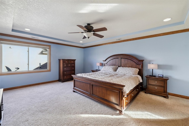 bedroom with baseboards, light carpet, a raised ceiling, and a textured ceiling