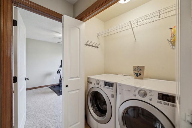 clothes washing area featuring washer and dryer, baseboards, carpet floors, and laundry area