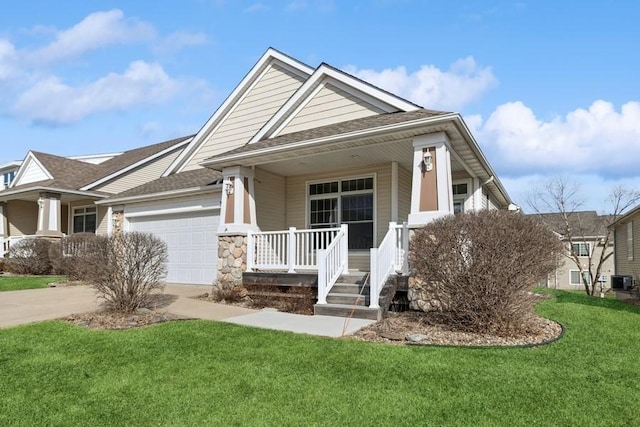 view of front facade featuring a shingled roof, a porch, a front yard, driveway, and an attached garage