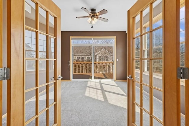 entryway featuring carpet flooring, french doors, and ceiling fan