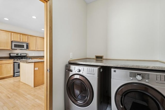 laundry room with washer and clothes dryer, laundry area, light wood-style flooring, and recessed lighting