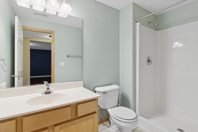 full bathroom featuring tile patterned flooring, visible vents, toilet, a stall shower, and vanity