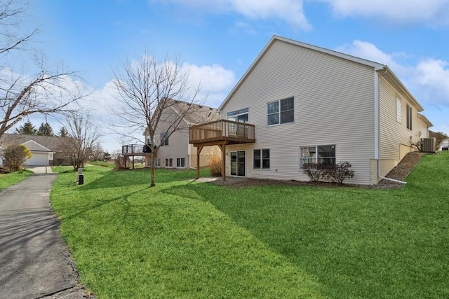 back of property featuring a deck, cooling unit, and a yard