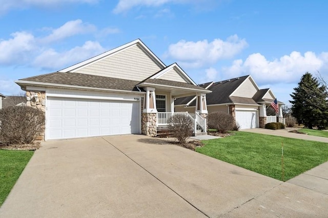 view of front of home featuring a shingled roof, a front lawn, a porch, concrete driveway, and an attached garage