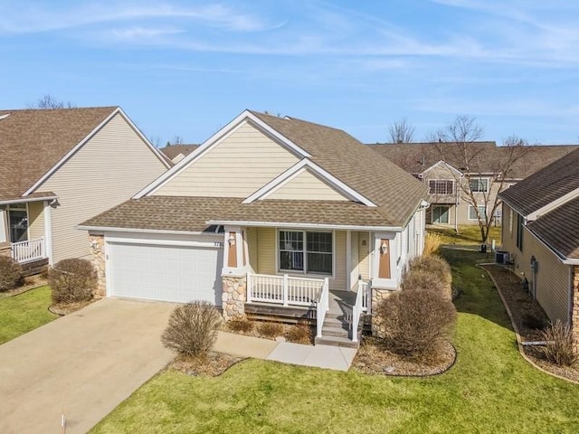 view of front of property with a porch, concrete driveway, a garage, and a shingled roof