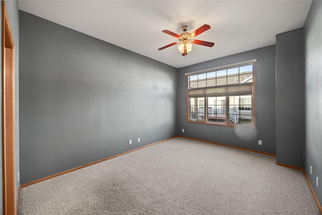 unfurnished room with ceiling fan, baseboards, and carpet floors