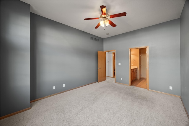 unfurnished bedroom with visible vents, light carpet, ensuite bath, baseboards, and ceiling fan