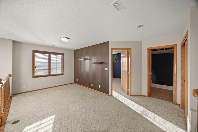 unfurnished bedroom featuring visible vents, carpet floors, a closet, and a spacious closet