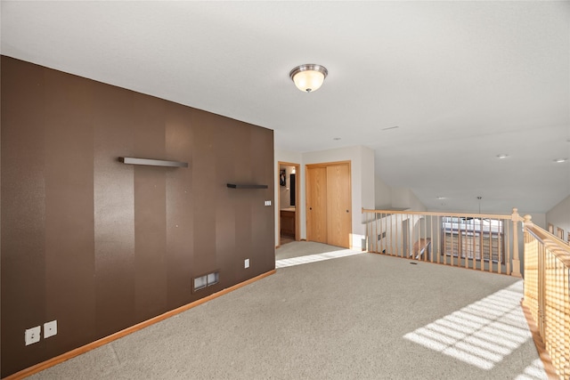 empty room featuring baseboards and carpet