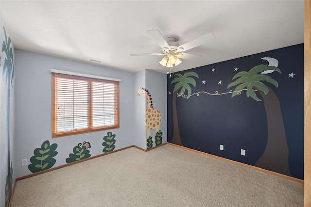 unfurnished room featuring visible vents, baseboards, carpet floors, and a ceiling fan