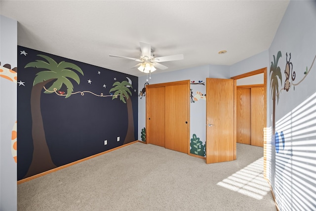 bedroom featuring a closet, ceiling fan, baseboards, and carpet