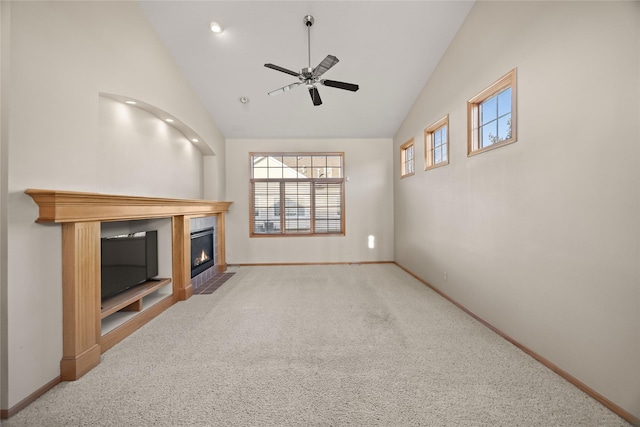 living room featuring a fireplace with flush hearth, high vaulted ceiling, carpet, baseboards, and ceiling fan