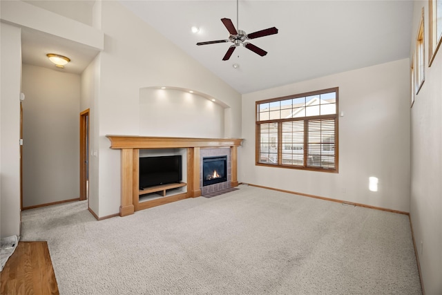 unfurnished living room with high vaulted ceiling, carpet, a fireplace, baseboards, and ceiling fan