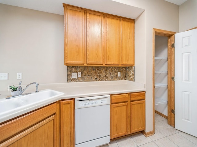 1904 NW Ashton Ln Unit 3, Ankeny, IA 50023 - kitchen featuring dishwasher, light tile patterned floors, backsplash, light countertops, and brown cabinetry