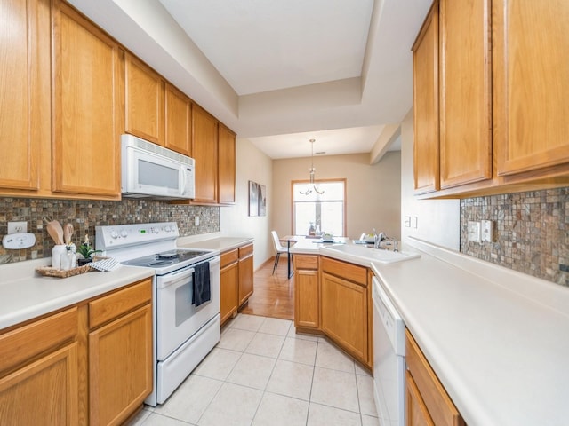 1904 NW Ashton Ln Unit 3, Ankeny, IA 50023 - kitchen with white appliances, light tile patterned flooring, light countertops, and backsplash