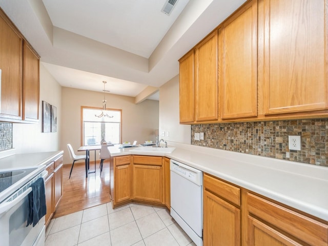 1904 NW Ashton Ln Unit 3, Ankeny, IA 50023 - kitchen featuring white appliances, a chandelier, a peninsula, backsplash, and light tile patterned flooring