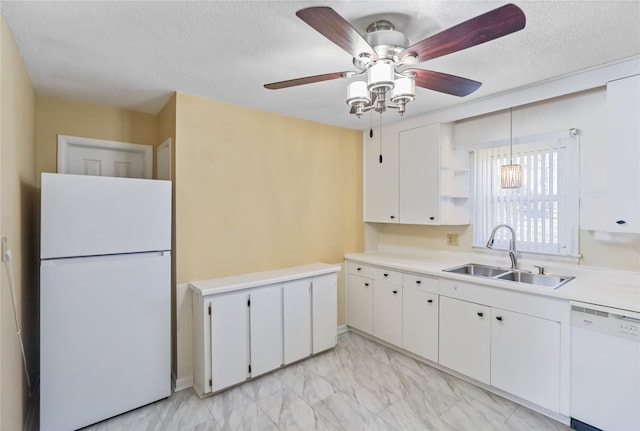 kitchen featuring white appliances, a sink, light countertops, white cabinets, and marble finish floor