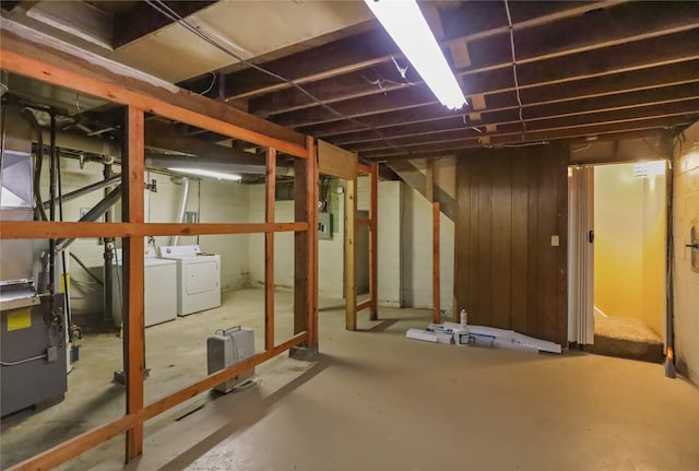 unfinished below grade area with separate washer and dryer and wooden walls