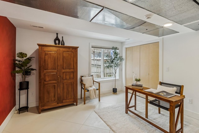 office area with light tile patterned floors, visible vents, and baseboards