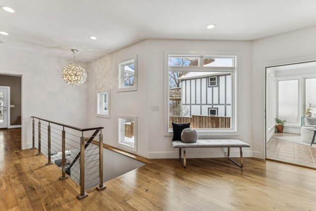 5740 Walnut Hill Ave, Des Moines, IA 50312 - hall with an upstairs landing, wood finished floors, recessed lighting, baseboards, and a chandelier