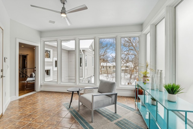 sunroom / solarium featuring visible vents and ceiling fan