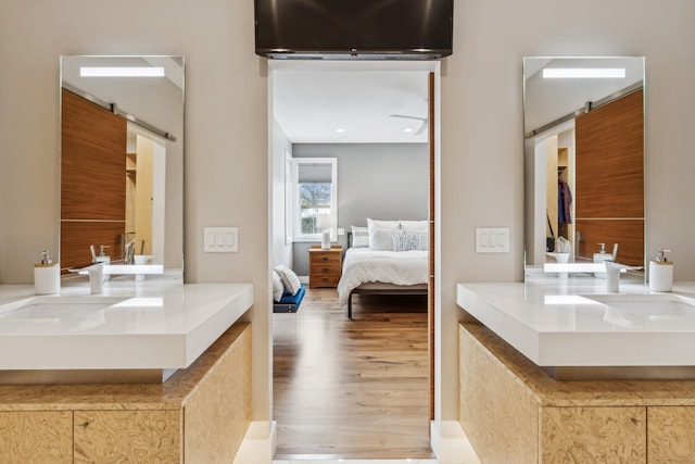 full bath with vanity, ensuite bathroom, and wood finished floors