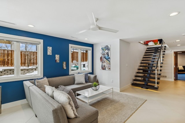 living area featuring recessed lighting, baseboards, a healthy amount of sunlight, and stairs