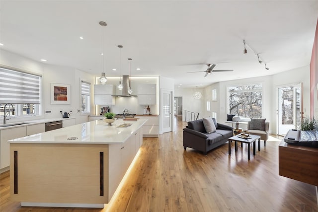 5740 Walnut Hill Ave, Des Moines, IA 50312 - kitchen featuring wall chimney exhaust hood, modern cabinets, a sink, dishwasher, and white cabinetry