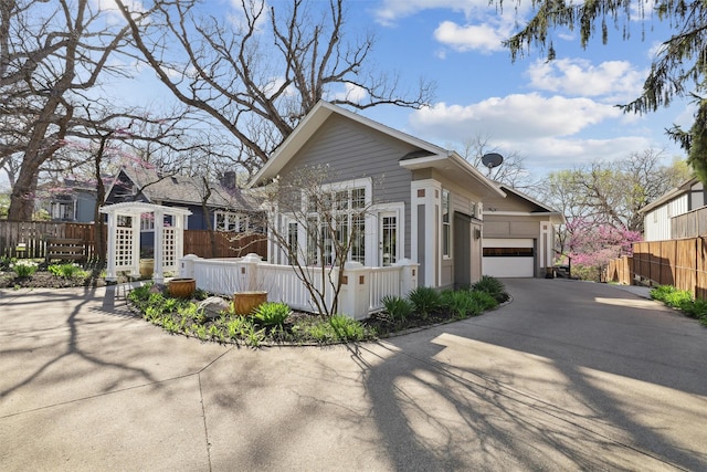 5740 Walnut Hill Ave, Des Moines, IA 50312 - view of front facade with concrete driveway and a garage