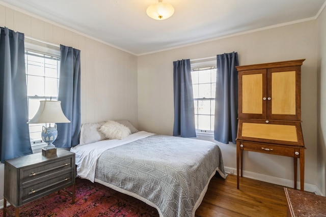 bedroom with dark wood-type flooring, baseboards, and ornamental molding