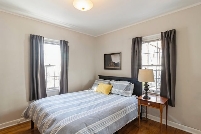 bedroom featuring dark wood finished floors and baseboards