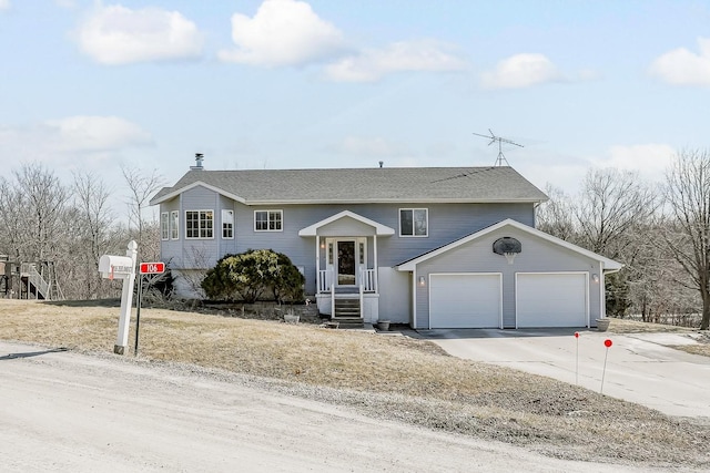 split foyer home featuring a garage and driveway