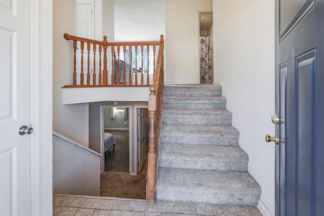 stairs with tile patterned floors